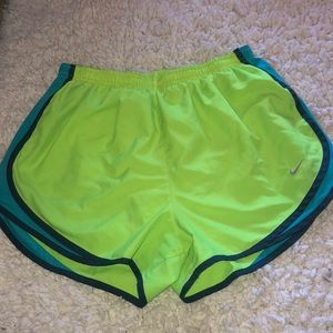 Blue and neon yellow Nike running shorts